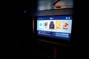 Illuminated screen of a small cinema in the dark